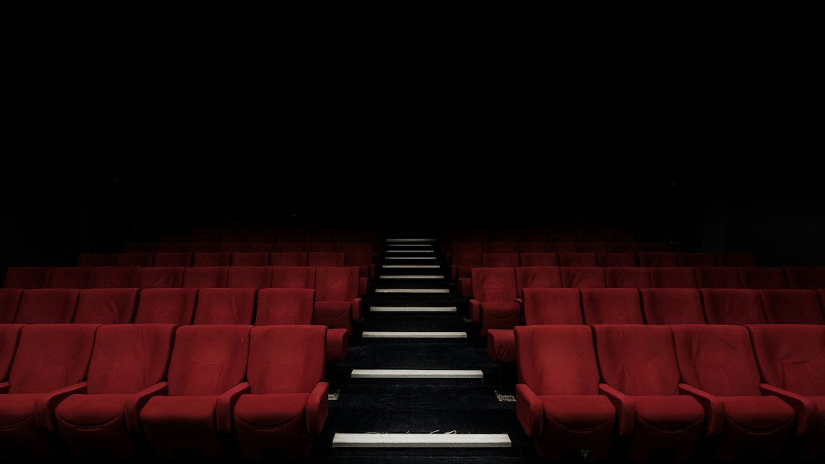 Audience watching a visually stunning blockbuster film in a large-format cinema auditorium