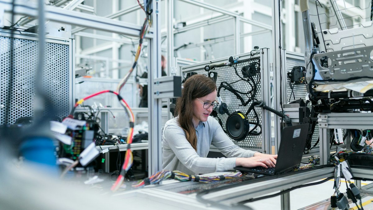 Advanced automated manufacturing facility with robotic assembly arms in an industrial hub